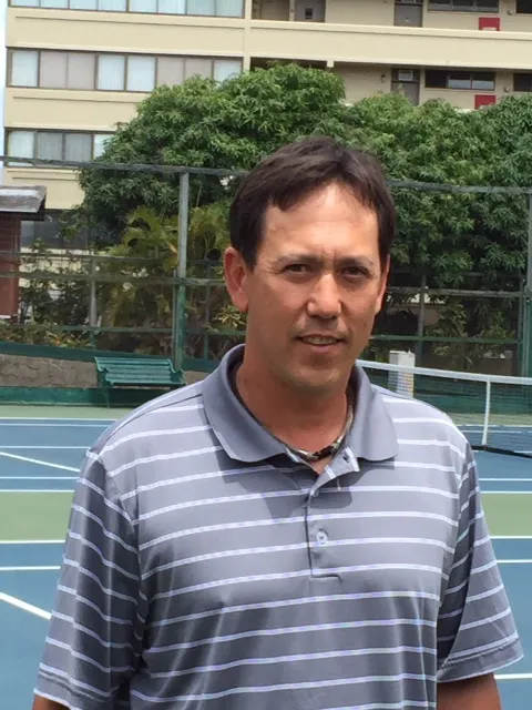 David Lam, BTC Tennis Director, on a tennis court